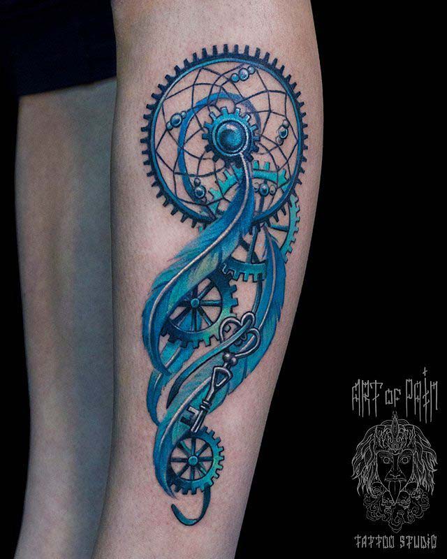 arm tattoo dreamcatche blue cogwheels