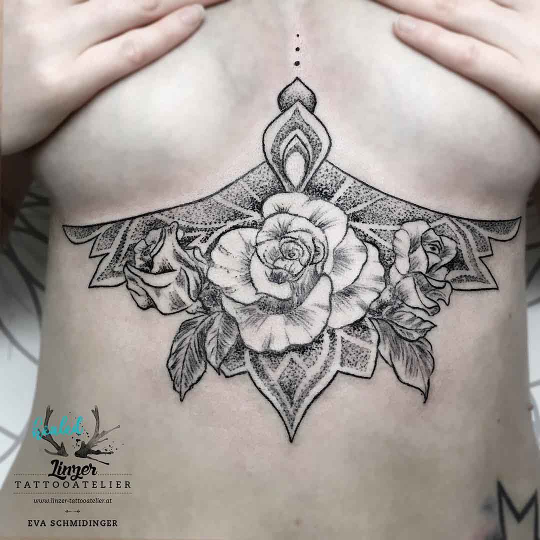 under breasts tattoo of rose