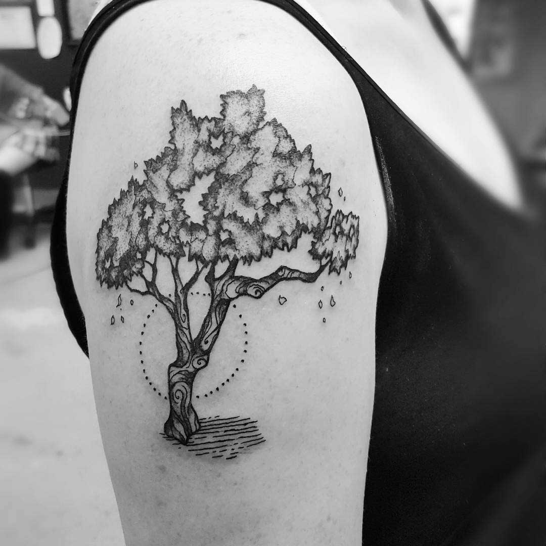 bkack and grey tree tattoo on shoulder