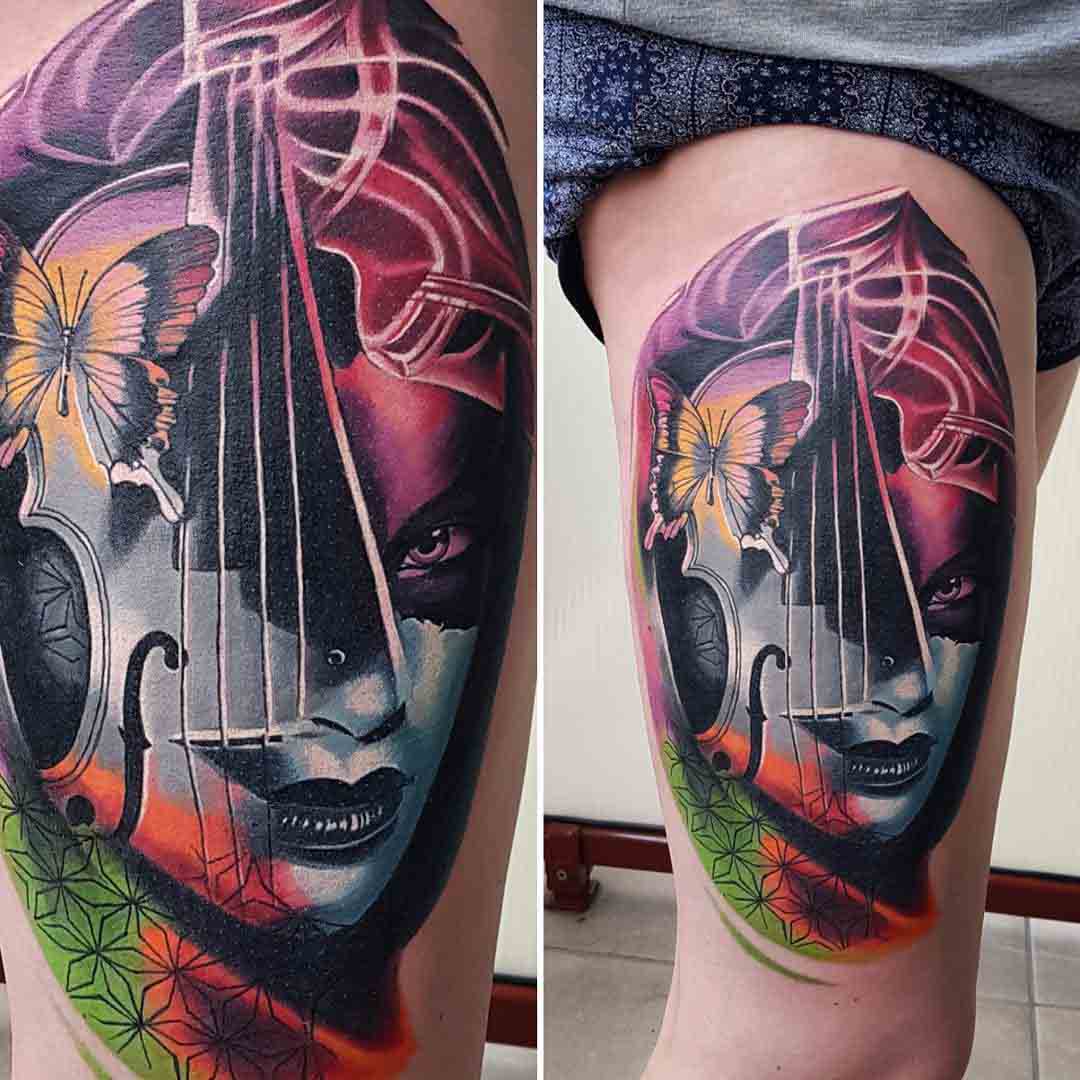 musician tattoo on thigh