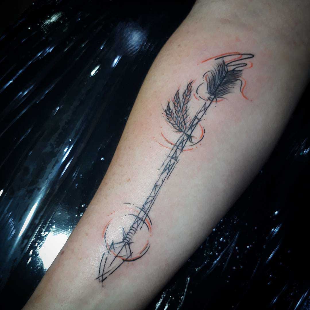 sketchy arrow tattoo on arm
