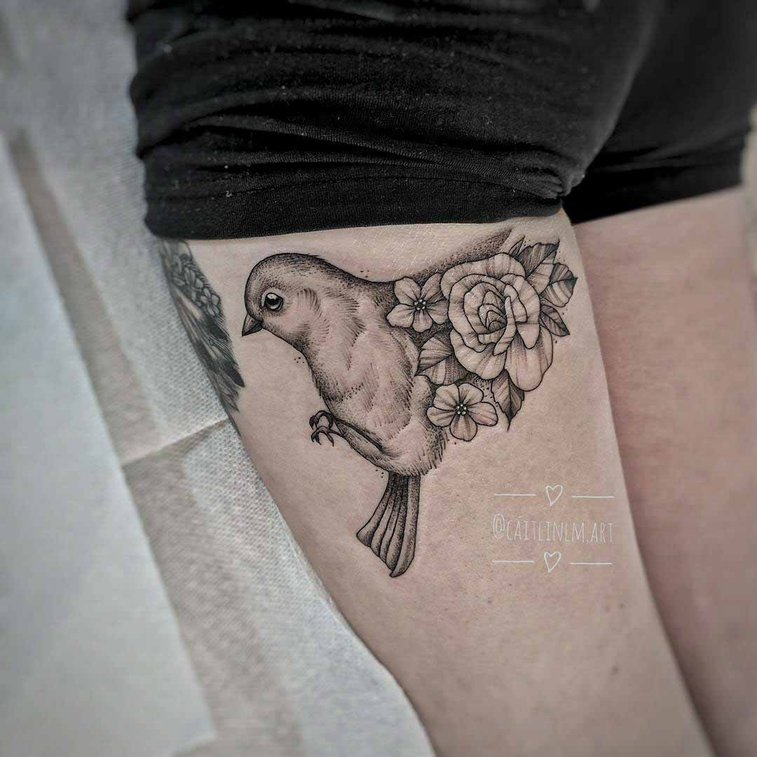 bird with flower tattoo on hip
