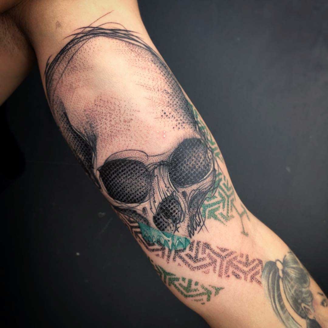bicep skull tattoo with dotwork ornament