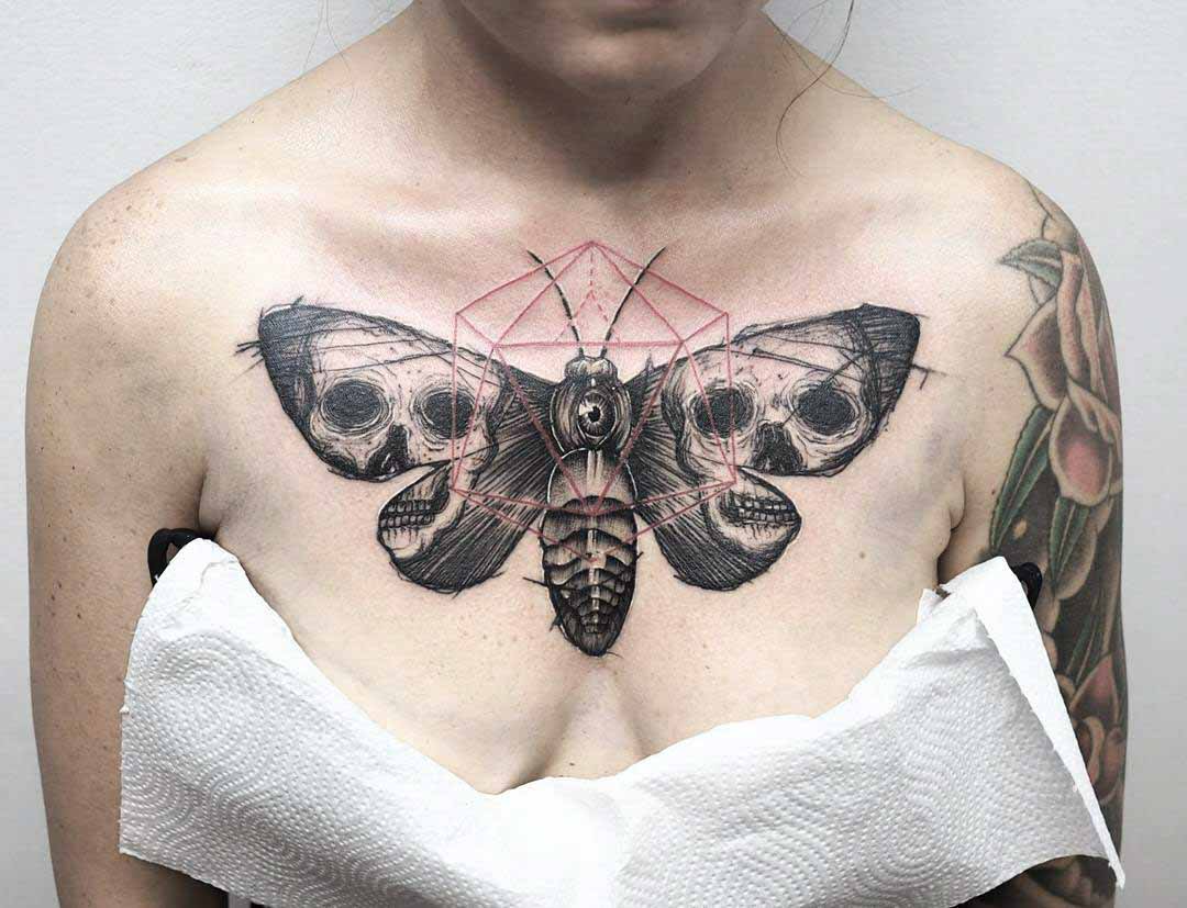 chest tattoo moth with skulls