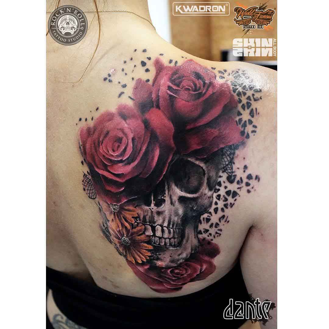 skull tattoo on shoulder blade with roses