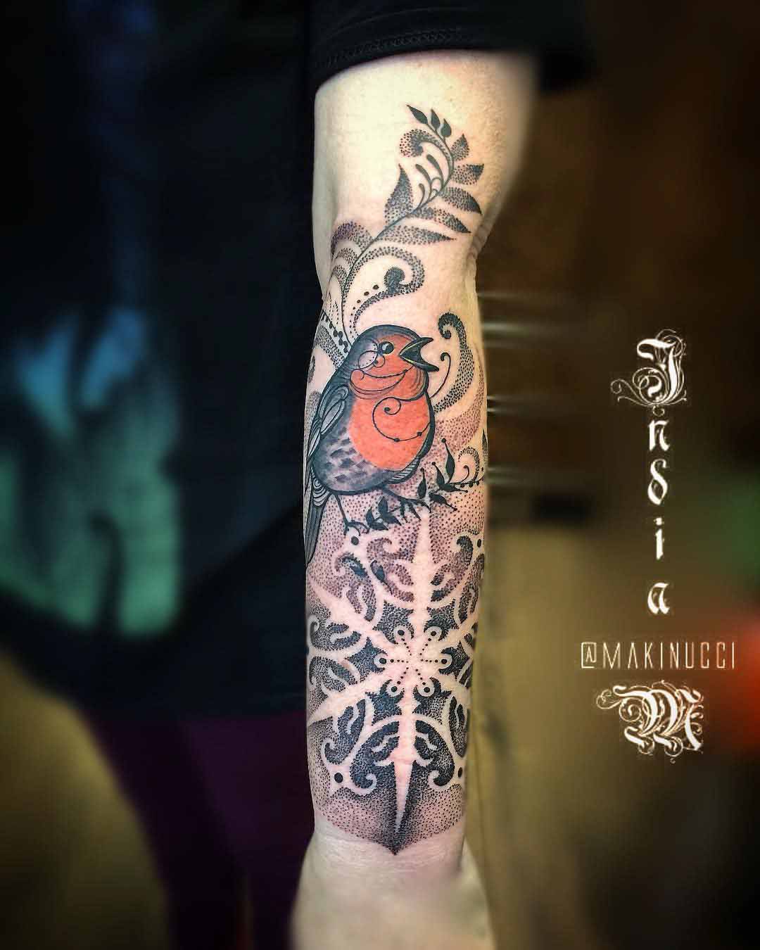 arm tattoo snowflake and robin bird