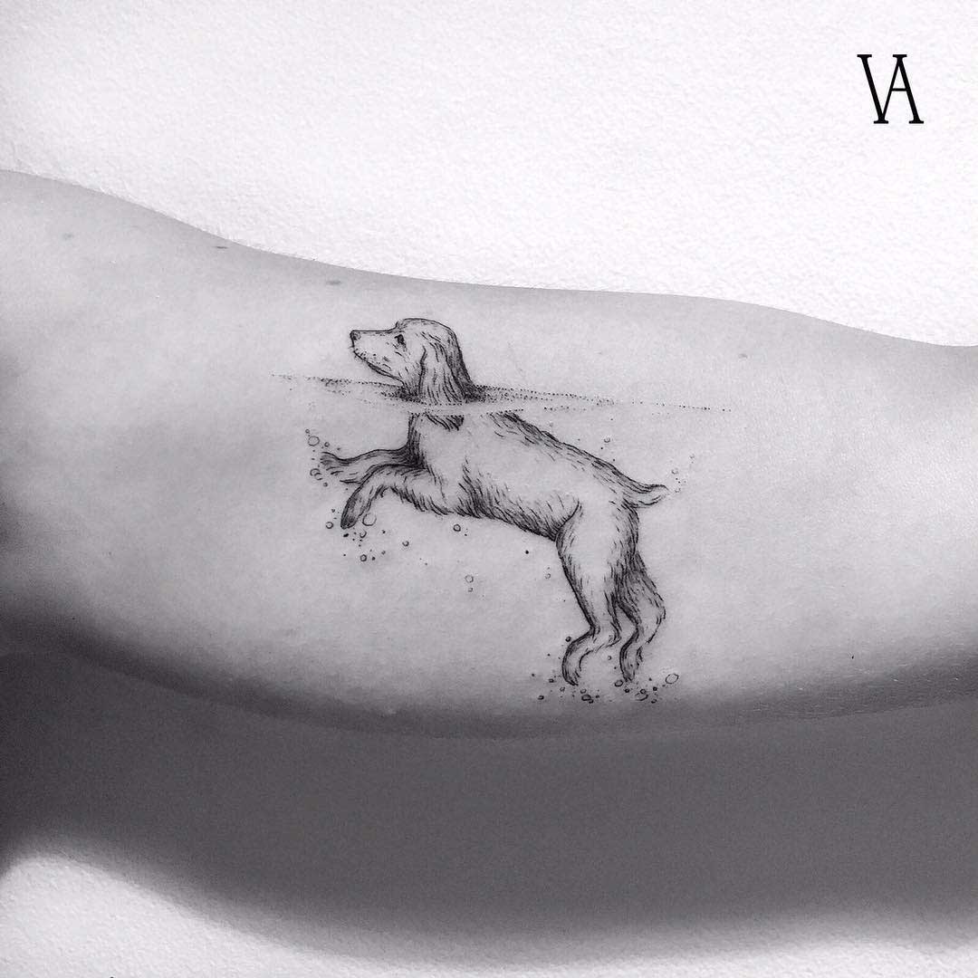 arm tattoo dog swimming