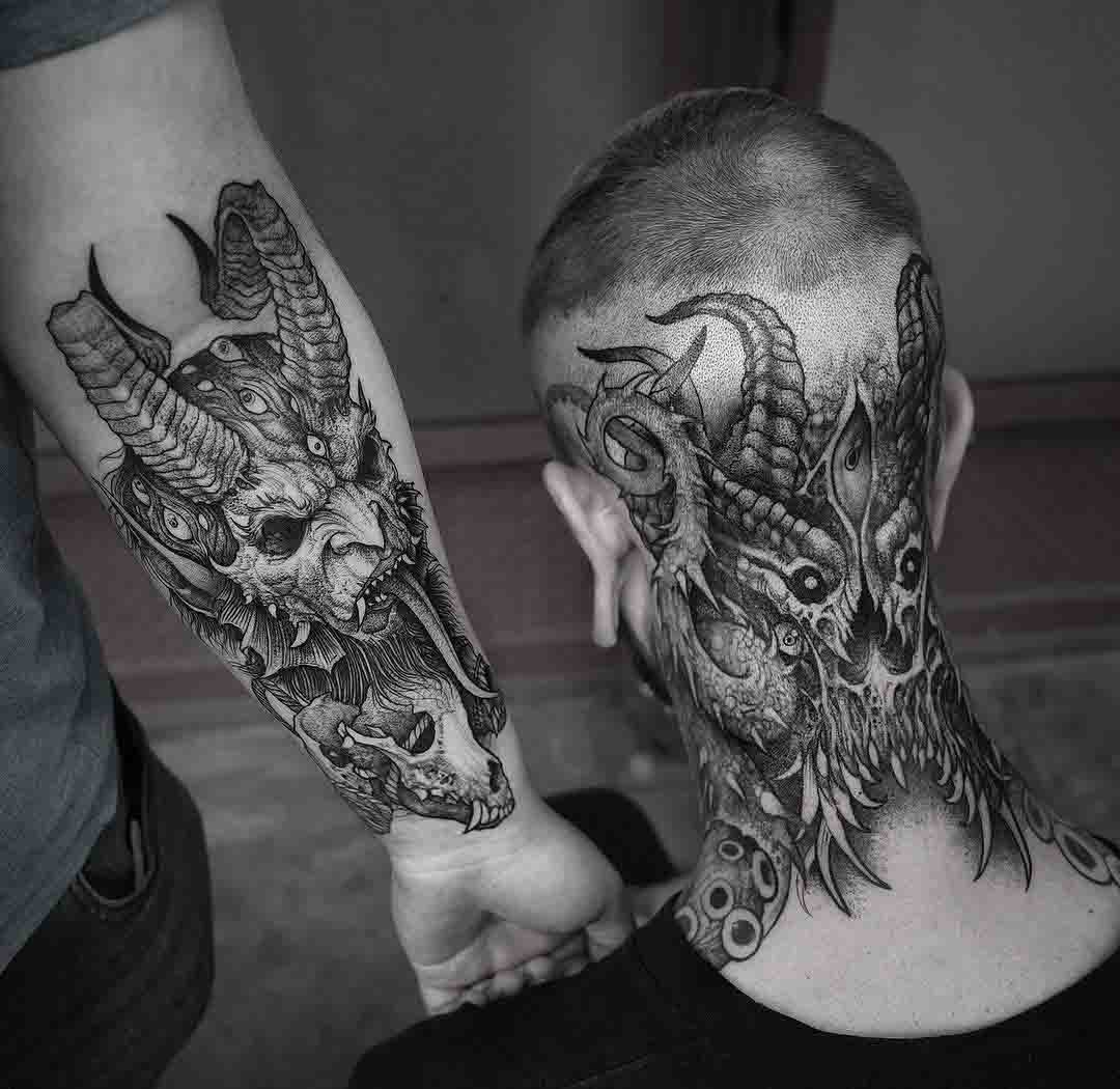 arm and neck demonic tattoos