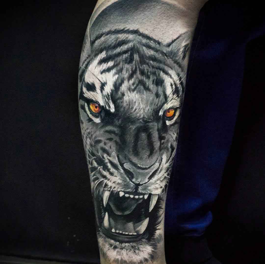 arm tattoo tiger with yellow eyes