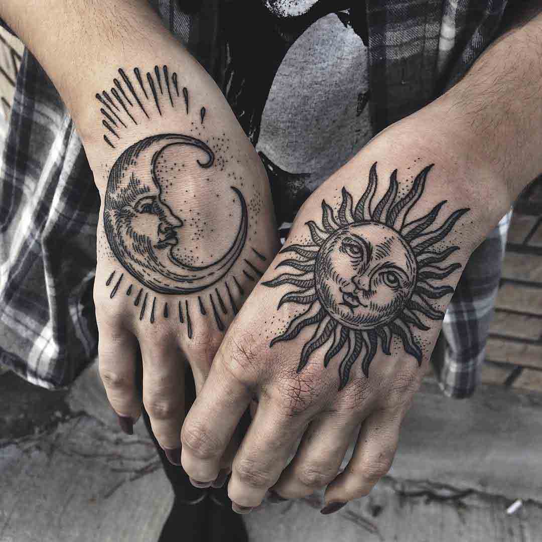 hand tattoos of moon and sun