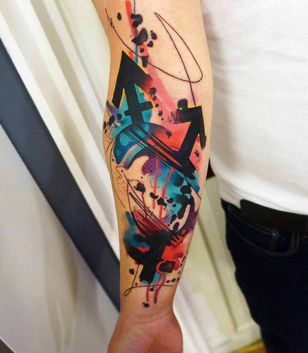 watercolor arrows tattoo on arm