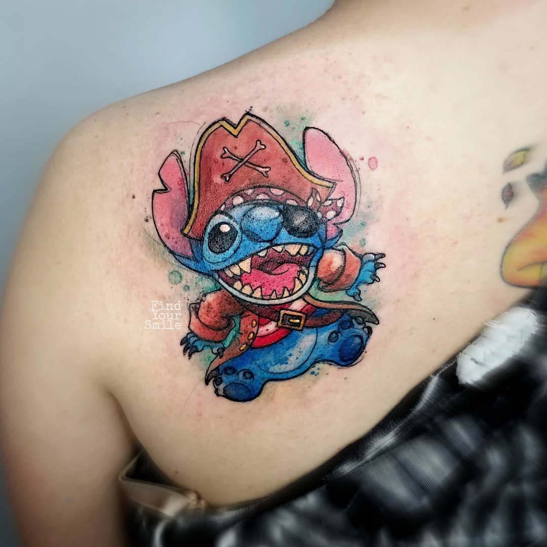 watercolor stitch tattoo on shoulder blade