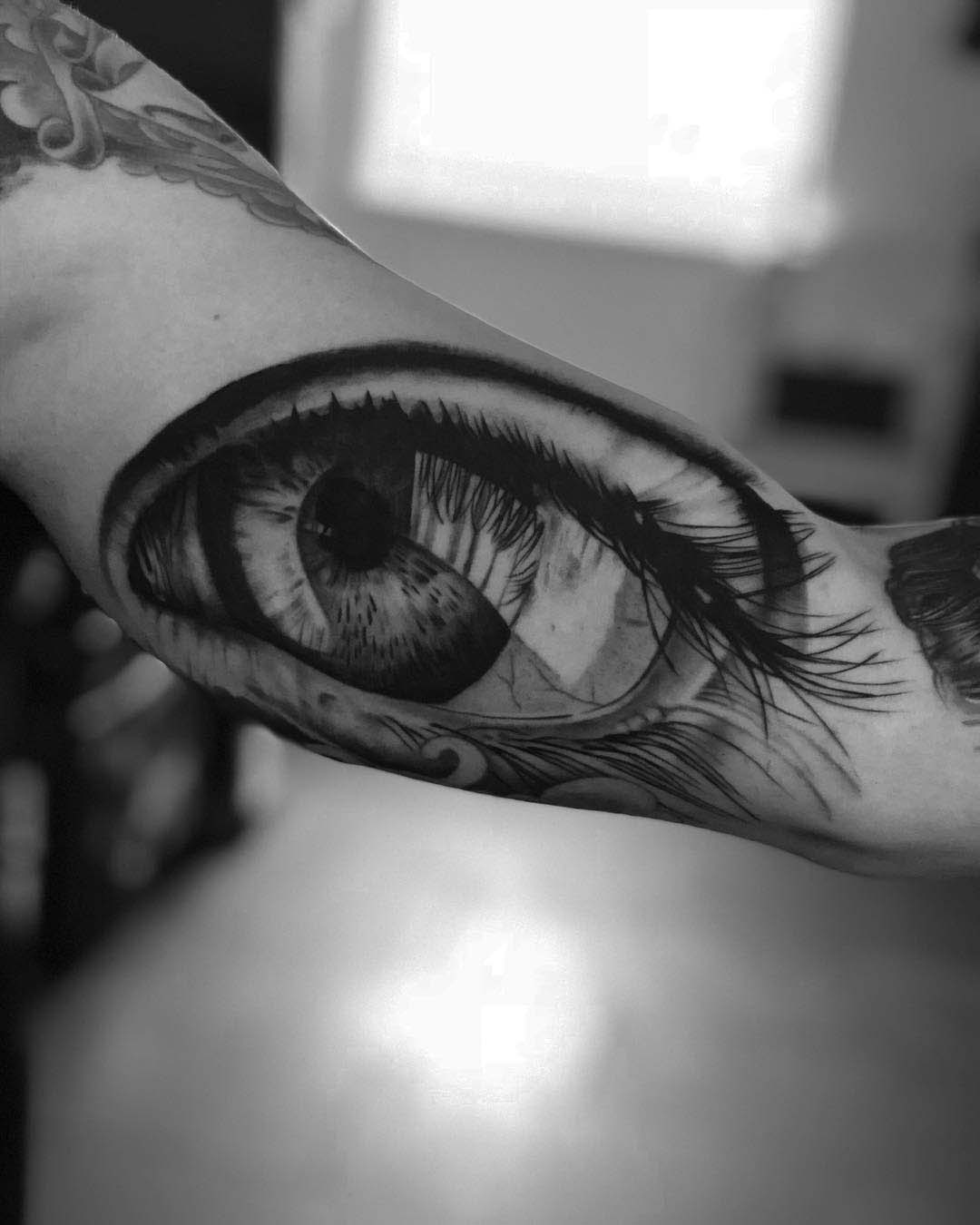 bicep tattoo black and grey eye