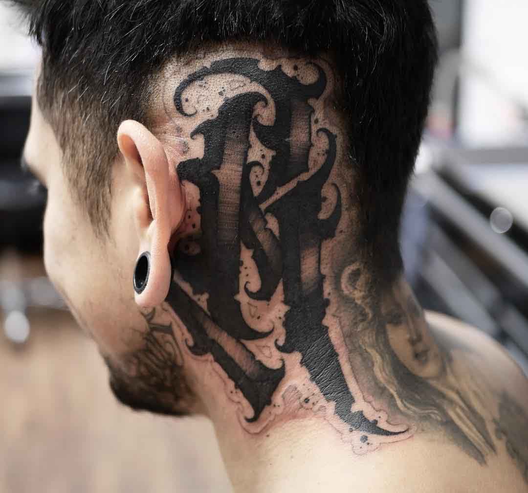 letter tattoo on head behind the ear