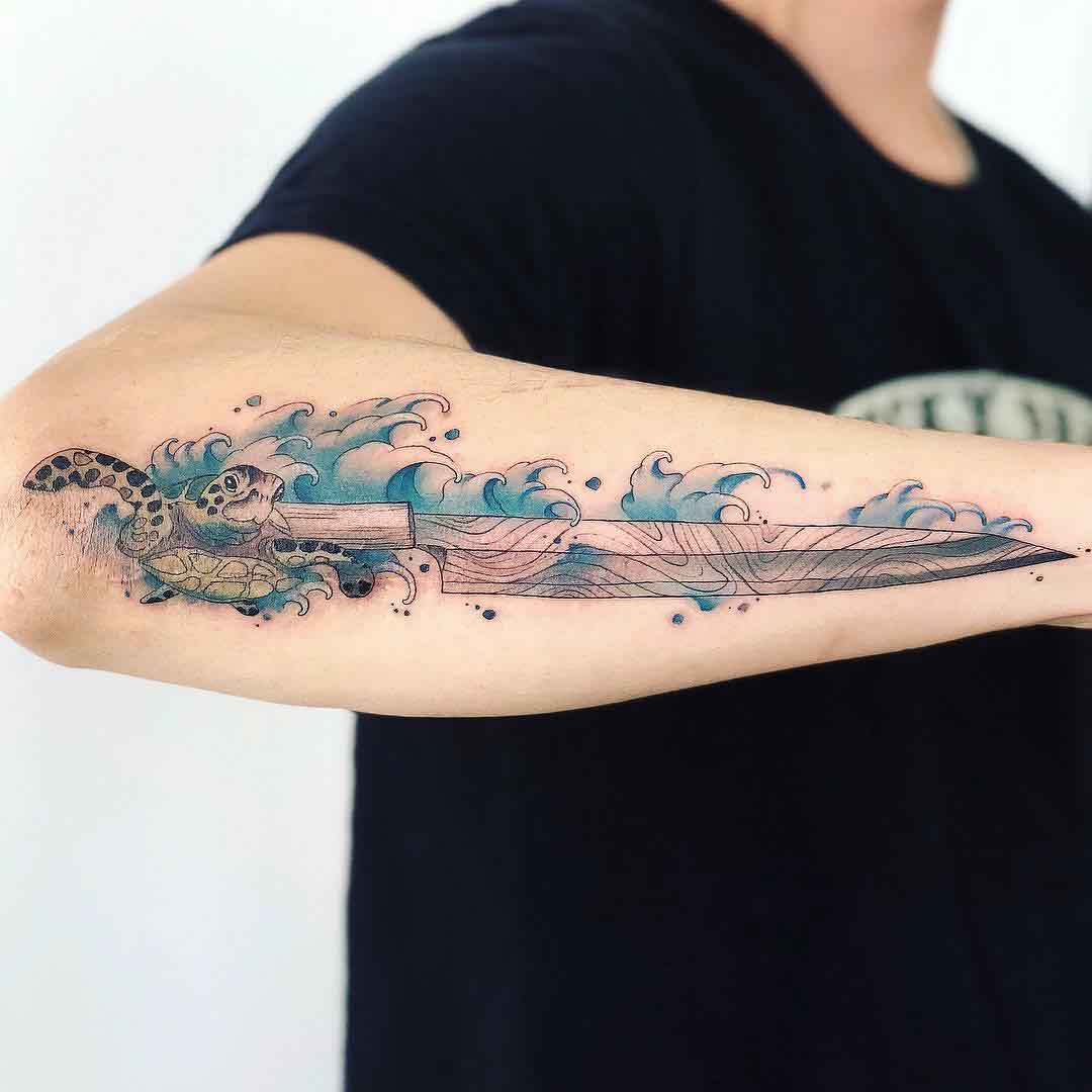forearm tattoo turtle and knife