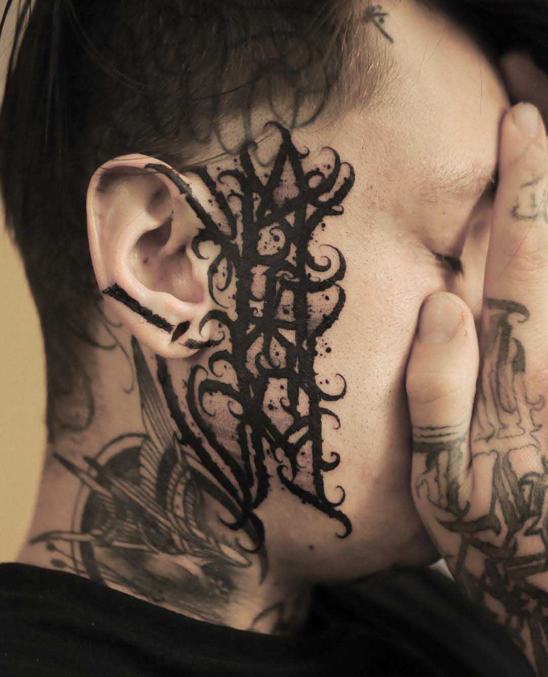 face tattoo lettering AMOR