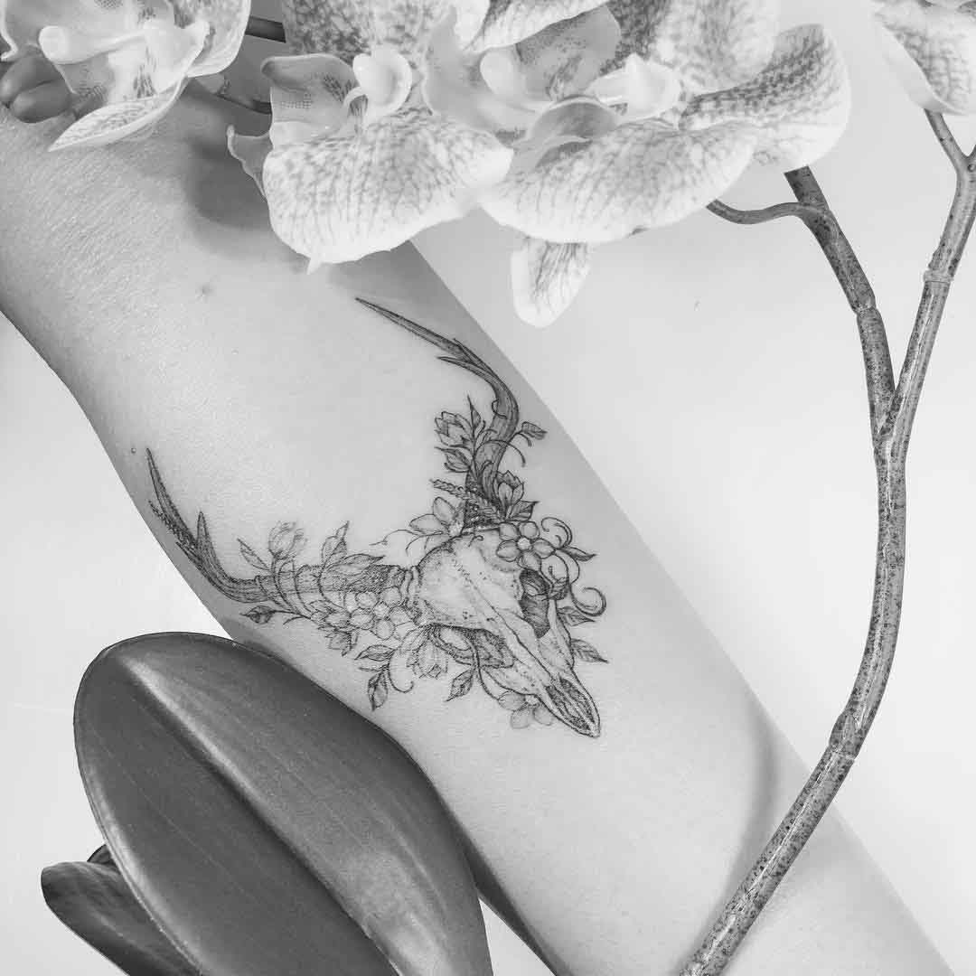 arm tattoo deer skull flowers