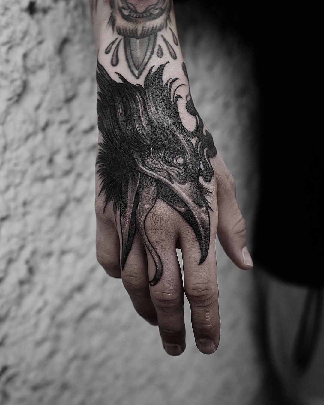 hand tattoo crow