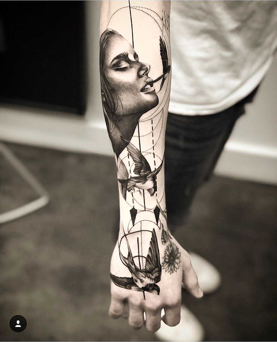 arm tattoo swallows